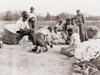 African Americans Enjoying Some Rest And Recreation After A Day Of Work Picking Cotton. Three Men Are Shooting Dice On The Edge Of Cotton Field While Others Watch. Ca. 1900. History - Item # VAREVCHISL014EC002