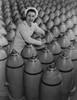 Canadian Woman Munitions Worker Tightening The Nose Plugs On 500-Pound Aerial Bombs. 1942-43 History - Item # VAREVCHISL036EC835
