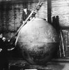 Auguste Piccard On A Ladder Examining The 'Nacelle' Construction In His Workshop. The A Spherical Aluminum Capsule Was Pressurized To Allow Ascent To High Altitude A Without Pressure Suit. Ca. 1930-1932. On May 27 History - Item # VAREVCCSUB002CS144