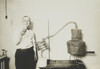 Moonshine Still Recently Confiscated By The Internal Revenue Bureau. An Employee Holds A Glass Of Alcohol Distilled From The Apparatus At The Treasury Department History - Item # VAREVCHISL042EC525