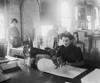 Middle-Aged Woman Sewing On A Belt Driven Singer Machine At The Richmond & Backus Company History - Item # VAREVCHISL021EC129
