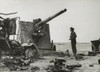 British Army Officer Looks At A Destroyed German Dual Purpose 88 Millimeter Gun. It Was Put Out Of Action By British Artillery Near El Gubbi. Ca. 1940-42 During World War 2. History - Item # VAREVCHISL036EC622