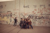 Multi-Ethnic Group Of Boys Smile In Front Of A Graffiti Covered Wall In The Poor Bronx Borough Of New York City. Ca. 1975. History - Item # VAREVCHISL031EC201