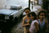 1970S America. Three Young Girls Pose In Front Of An Abandoned Car In Brooklyn History - Item # VAREVCHCDARNAEC009