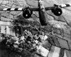 Aerial View Of A A-20 G Havoc Light Bomber With D-Day 'Invasion Stripes' Painted On Its Wings. Plumes Of Smoke Rise From The Forest Cerisy History - Item # VAREVCHISL037EC218