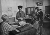 Turkmenian Collective Farmers Receiving Their Share Of Yearly Profits In The 1930S. The Farm Administrator Calculates With An Abacus. Pictures Of Stalin And Lenin Hang On The Walls. History - Item # VAREVCHISL040EC583