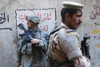 Us And Iraqi Army Soldiers Stand Guard A Market In The Al Doura District Of Baghdad Iraq Providing Security For Us Ambassador Ryan Crocker Who Was Touring The City. April 5 2007. History - Item # VAREVCHISL027EC205