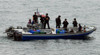 U.S. Sailors And Coast Guardsmen Question Four Suspected Drug Smugglers After Their Boat Was Intercepted In The Eastern Pacific Ocean March 31 2010. History - Item # VAREVCHISL024EC251