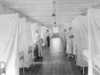 Spanish Flu Epidemic 1918-19. Nurses And Orderlies Stand By Beds Separated By Sheets To Isolate Patients In The InfluenzaPneumonia Ward Of Walter Reed General Hospital History - Item # VAREVCHISL015EC027