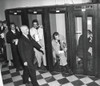President Harry Truman Walks Past Reporters In The Telephone Booths The Old State Department Building. They Are Reporting Back To Their Headquarters After Truman'S Press Conference History - Item # VAREVCHISL039EC996