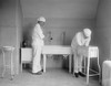 Surgeon And Anesthesiologist Carefully Wash Their Hands And Lower Arms In Specialized Sinks. Before Antibiotics Post-Operative Infection Was A Serious Concern. 1922 In A Hospital In Washington History - Item # VAREVCHISL043EC209