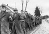 American Prisoners Of War Are Marched Along A Road During The Battle Of The Bulge. Still From A Captured German Film. Ca. Dec. 10-17 History - Item # VAREVCHISL038EC058