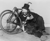 Hobo Clown Joe Jackson Reclining Against A Disassembled Bicycle At The New York World'S Fair In 1940. His Pantomime Act Incorporated Comic Stunt Bicycling And Was Taken Over By His Son History - Item # VAREVCHISL040EC467