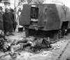 The 1956 Hungarian Uprising. The Bodies Of Two Russian Soldiers Lying Beside Their Wrecked Armored Car In A Budapest Street As Bystanders Look On. Oct. 30 History - Item # VAREVCCSUA001CS494