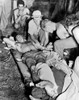 Blood Transfusion. A Wounded American Soldier Gets A Blood Transfusion While Assistants Hover About The Improvised Cot. The Scene Is "Somewhere In New Guinea" History - Item # VAREVCHCDLCGBEC667