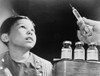 Child Looks At A Syringe With Poliomyelitis Vaccine. The Salk Vaccine History - Item # VAREVCHISL019EC081