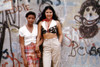 1970S America. Two Young Girls Pose In Front Of A Graffitied Wall In Brooklyn History - Item # VAREVCHCDARNAEC008
