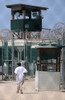 Under The Guard Tower A Detainee Walks In The Recreation Yard At Camp Delta The Military Prison For Suspected Taliban And Al-Qaeda Combatants At Guantanamo Bay Naval Base Cuba. June 8 2010. History - Item # VAREVCHISL024EC296