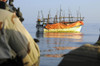 Back View Of U.S. Sailors With Weapons Ready As They Approach A Ramshackle Dhow In The Gulf Of Aden. Such Boats Are Used By Pirates And Refugees. Jan. 1 2010 History - Item # VAREVCHISL024EC250
