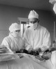 Assisting Surgeon And Surgical Nurse With Specialized Instruments During An Operation. Blood Can Be Seen In Surgical Area. 1922 In A Hospital In Washington History - Item # VAREVCHISL043EC213