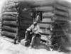 Log Cabin, C1895. /Nan African American Man Seated On A Tree Stump, Outside A Log Cabin In Rural America While Pouring A Drink Into Cup With A Young Girl Seated In The Window Above Him. Photograph, C1895. Poster Print by Granger Collection - Item # V