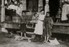 Family of Peter Elvis, New Orleans, La. All except smallest baby work in the Barataria Canning Company. Youngest boy, Jo., seven years old works Saturdays. Alma, the three year-old by the door is "learnin' the trade" her mother said. Poster Print - I