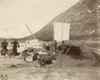 Yukon Territory, C1897. /Ntwo Men Repairing A Leak In A Boat On The Shore Of A River, While Three Other Men Are Standing Next To The Off-Loaded Supplies, In The Yukon Territory. Photograph, C1897. Poster Print by Granger Collection - Item # VARGRC011