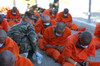 U.S. Military Police Woman Provides Water To Chained Detainees As They Arrive At Camp X-Ray At Guantanamo Bay Naval Base. The Prisoners Were Believed By The U.S. Military To Be Associated With Al-Qaeda Or The Taliban. Feb. 12 2002. - Item # VAREVCHIS