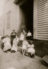 Crocheting on underwear at home. Carmina Caruso, 10 years old, a regular worker; sister Mary, 5 years old, learning; mother and neighbor sitting out in unkempt side yard all day long. Sometimes they walk up and down the street as they work. Poster Pr