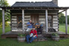 Banjo player Kevin Harris with the Huntley Sisters Blue Grass Group, Larry McWilliams on the fiddle and Nancy Muse on the guitar pose at the one-room log cabin that once served as a stagecoach stop in Tuscumbia, Alabama Poster Print - Item # VARBLL05