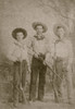 Three Armed And Dangerous Young Texas Cowboys. Three Young Men Dressed In Boots And Hats And Armed With An Array Of Weaponry Including Lever Action Rifles And Pistols Menacingly Tucked In Their Belts. Poster Print by L. Hartmann - Item # VARBLL058740