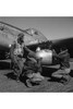 Photograph shows Tuskegee airman Edward C. Gleed, Lawrence, KS, Class 42-K, with two unidentified crewmen adjusting an external seventy-five gallon drop taken on the wing of a P-5/D, "Creamer's Dream." Poster Print by unknown - Item # VARBLL058724556