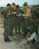 Vietnam War. A Suspected Viet Cong Sits On The Ground With A Black Bag Over His Head While Several Us Soldiers Examine Papers. He Was Captured During An Attack On An American Outpost Near The Cambodian Border In South Vietnam. Dec. 20 - Item # VAREVC