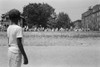 Anti-Integration Rally, 1959. /Na Young African American Boy Watching A Group Of People Marching To Protest The Admission Of The 'Little Rock Nine' To Central High School In Little Rock, Arkansas. Photograph By John T. Bledsoe, 1959. Poster Print by