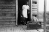 Migrant Worker, 1940. /Na Florida Migrant Worker Bringing Her Luggage Outside In Preparation For A Trip From Belcross, North Carolina To Another Job At Onley, Virginia. Photograph By Jack Delano, July 1940. Poster Print by Granger Collection - Item #