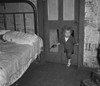 Coal Miner'S Child, 1938. /Ncoal Miner'S Child Using A Hole In The Door To Enter A Bedroom With A Smoking Pipe In One Hand And A Gun In The Other In Bertha Hill, West Virginia. Photograph By Marion Post Wolcott, September 1938. Poster Print by Grange