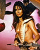 Caroline Munro - holding spear pink background Photo Print (8 x 10) - Item # DAP14692