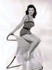 Debra Paget- In a one piece sitting on a chair Photo Print (8 x 10) - Item # DAP16718