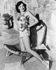 Gene Tierney - Kneeling on Wicker Pool Chair Photo Print (8 x 10) - Item # DAP18172