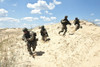 Squad of soldiers run through the desert through the military operation. Poster Print by Oleg Zabielin/Stocktrek Images - Item # VARPSTZAB100135M