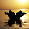 Silhouette of Army soldiers crossing a river at sunset. Poster Print by Oleg Zabielin/Stocktrek Images - Item # VARPSTZAB102875M