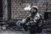 Special forces soldier smoking a cigarette while sitting in a ruined building. Poster Print by Oleg Zabielin/Stocktrek I - Item # VARPSTZAB103033M