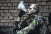 Special forces soldier smoking a cigarette while sitting in a ruined building. Poster Print by Oleg Zabielin/Stocktrek I - Item # VARPSTZAB103035M