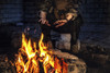 Special forces soldier warming his hands over a fire in a ruined building. Poster Print by Oleg Zabielin/Stocktrek Image - Item # VARPSTZAB103042M
