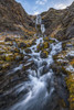 Waterfall along rugged rocks with lichen and moss along the road; Iceland Poster Print by Robert Postma / Design Pics - Item # VARDPI12547731