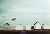 Small wooden buildings in a row on the beach with a view of the ocean; England Poster Print by Melody Davis / Design Pics - Item # VARDPI12388251