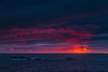 Clouds glowing a bright pink on the horizon over water; Bonavista, Newfoundland, Canada Poster Print by Aaron Von Hagen / Design Pics - Item # VARDPI12514598