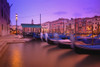 Gondolas moored along the shoreline of the Grand Canal during a vibrant sunset; Venice, Italy Poster Print by Carson Ganci / Design Pics - Item # VARDPI12553854