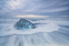 Large ice block laying on the shores of Southern Iceland while waves crash on shore; Iceland Poster Print by Robert Postma / Design Pics - Item # VARDPI12550351