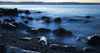 Beautiful blue misty ocean washing in against rocks on a West Coast beach; Greymouth, New Zealand Poster Print by Nicola M Mora / Design Pics - Item # VARDPI12392085